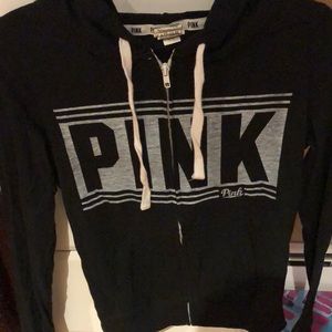 pink zip up black sweatshirt